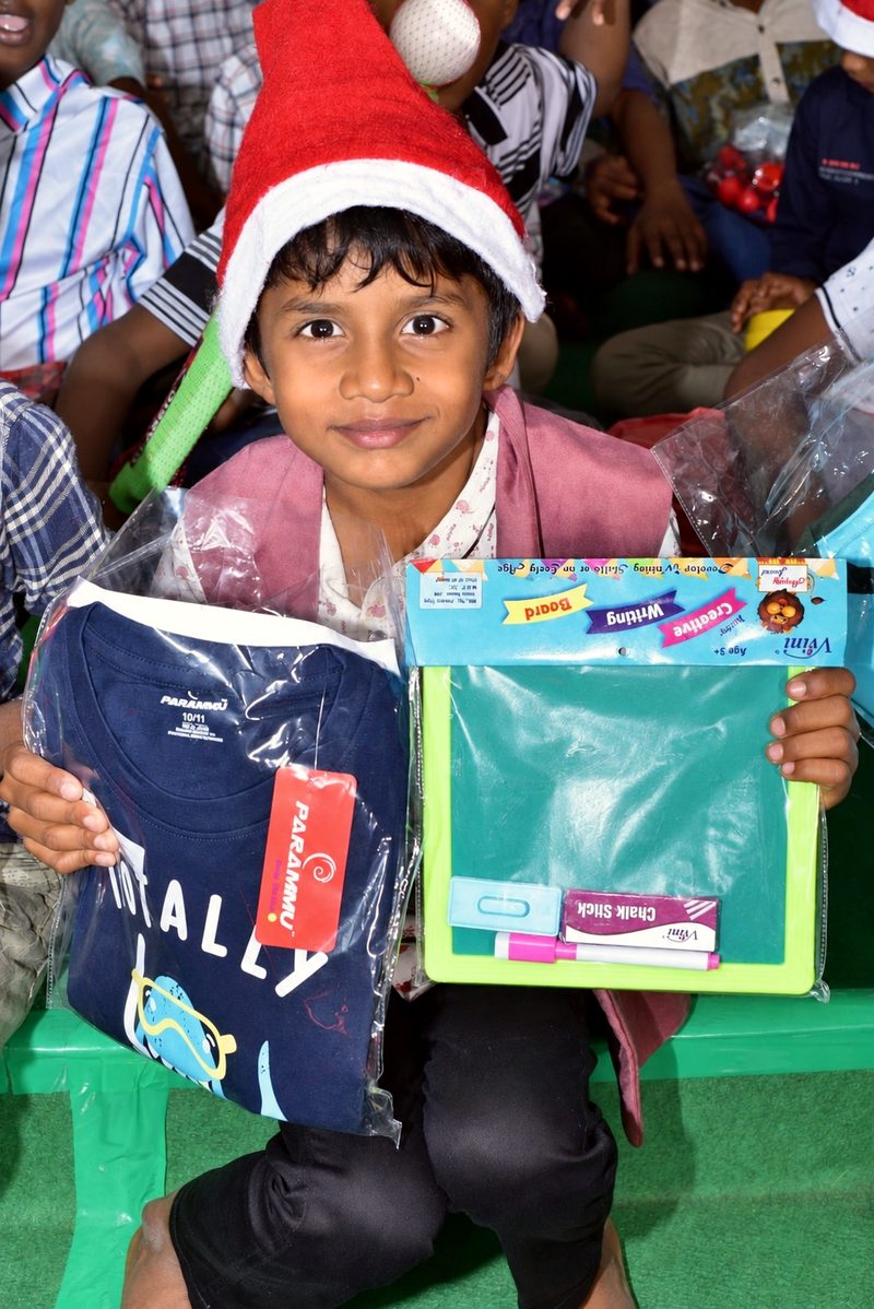 A girl in Cheyyar, India, holding new school supplies